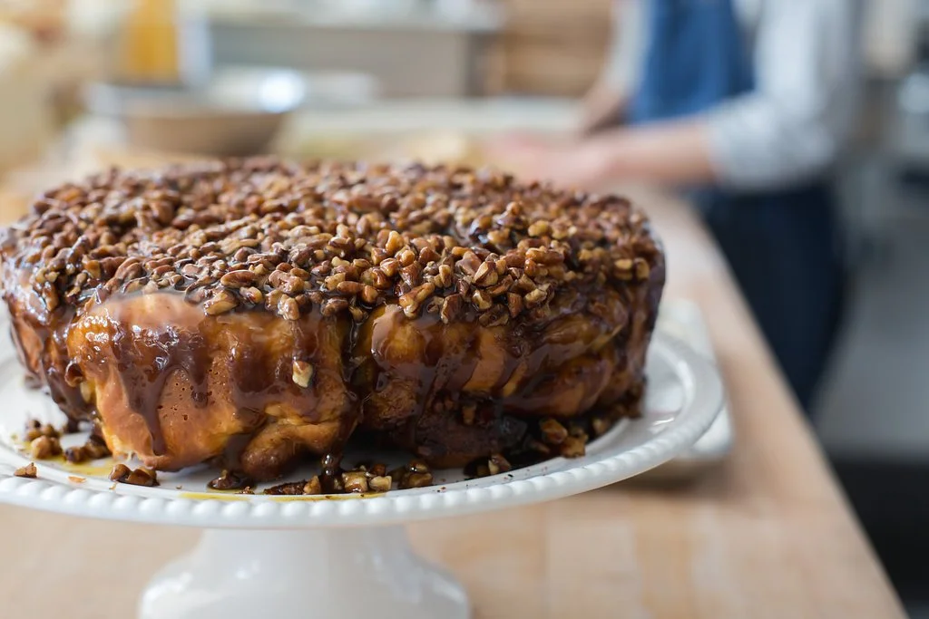 A cake on a white cake stand at The Buttery