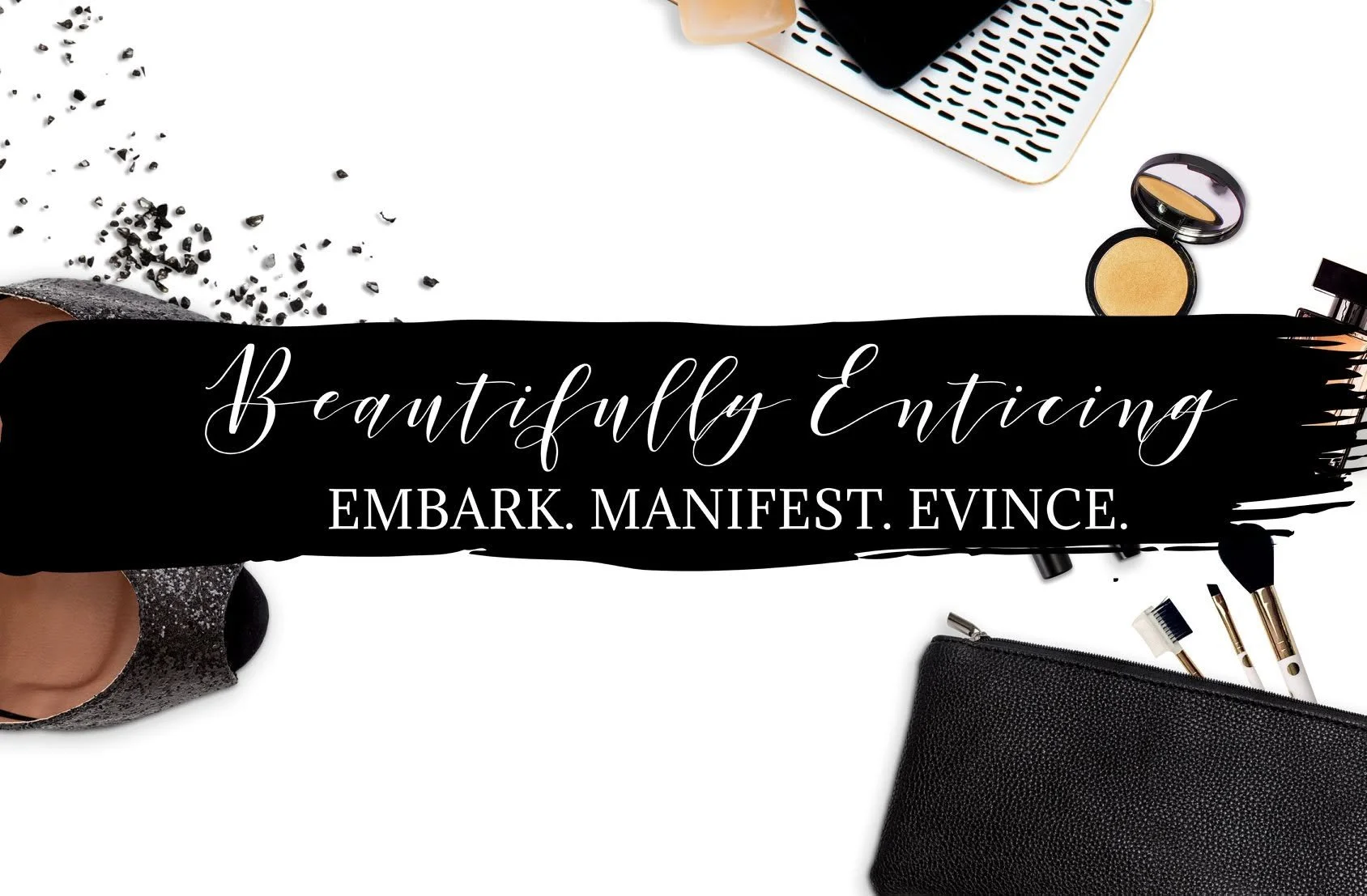 Flat lay of makeup and beauty products including eyeshadow, brushes, pouch, and a bowl of sugar on a white background with the text 'Beautifully Enticing. Embark. Manifest. Evince.'