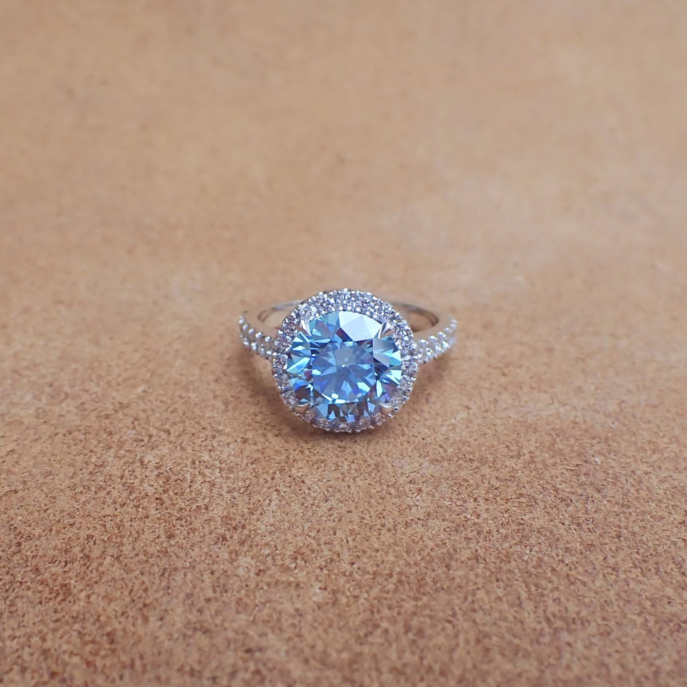 18k White Gold Ring with a 3.09 carat Lab Grown Blue Diamond and 0.62 carats of Lab Diamond - $5490  (3.09 carat Round Brilliant Cut Lab Grown Diamond with Clarity Grade VVS2 Color Grade Fancy Vivid Blue with IGI Report: LG756576801) 