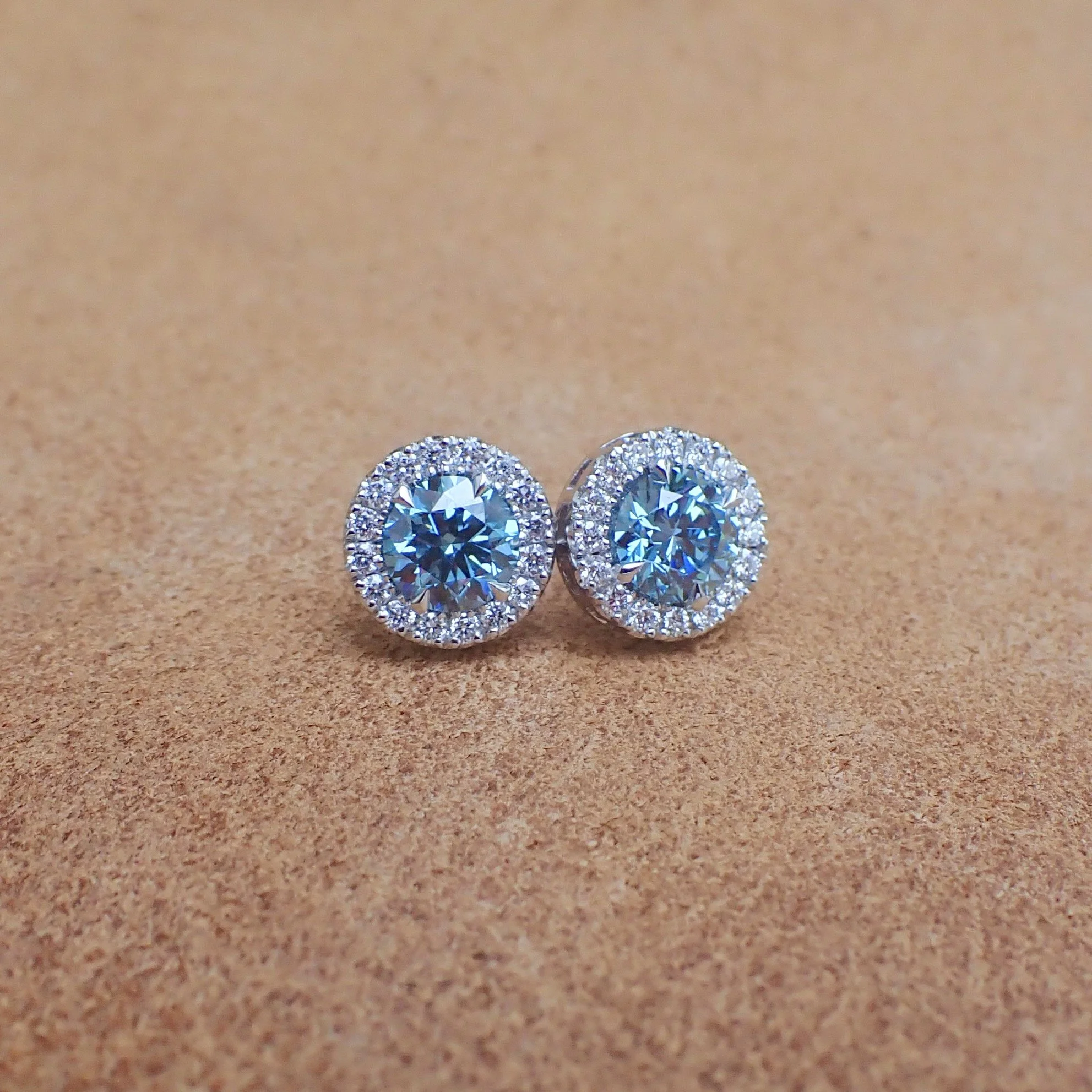 18k White Gold Stud Earrings set with 2.09 carats of Lab Grown Blue Diamond and 0.48 carats of Lab Diamond - $4455  (1.04 carat Round Brilliant Cut Lab Grown Diamond with Clarity Grade VVS2 Color Grade Fancy Vivid Blue with IGI Report: LG807649103)  