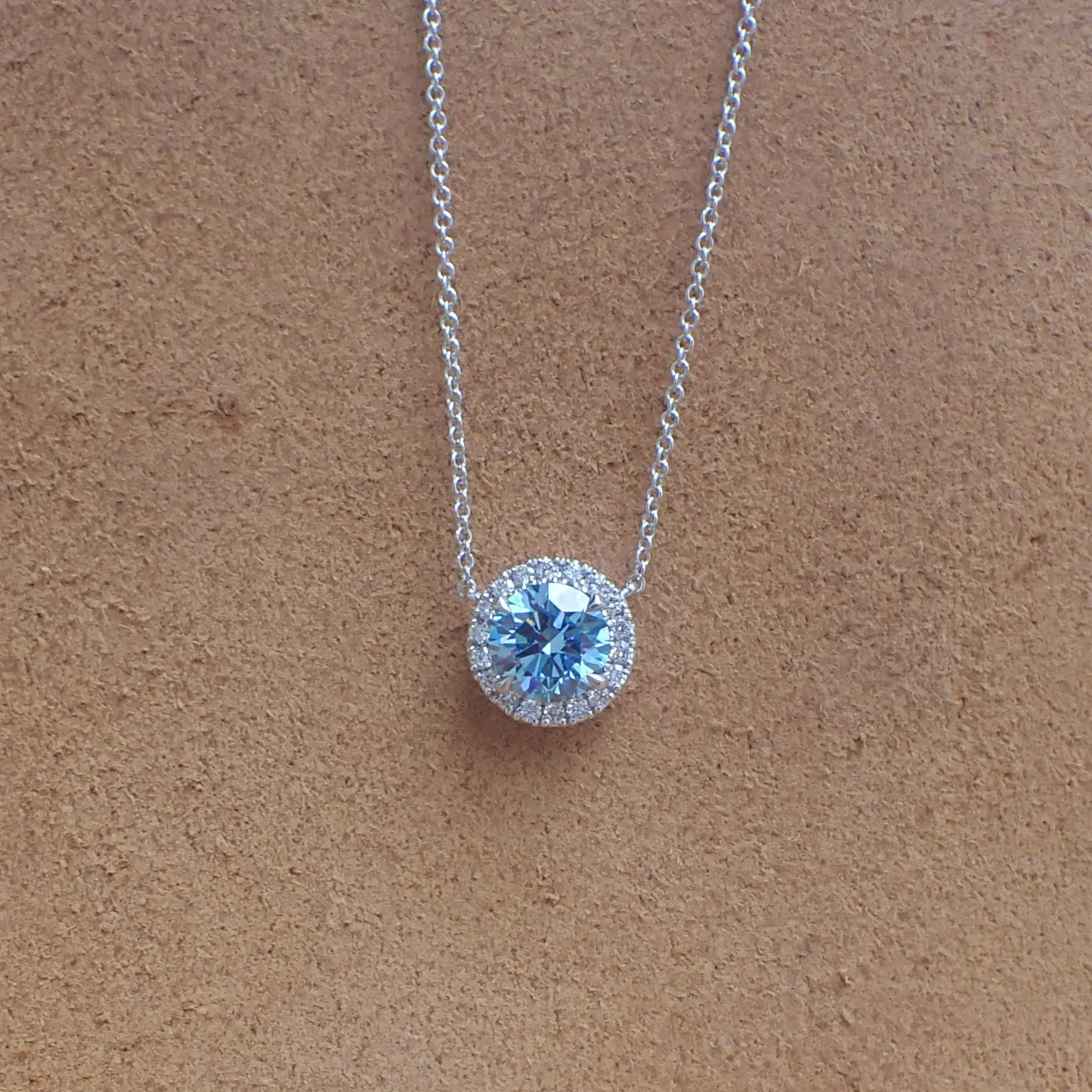 18k White Gold Pendant with a 2.01 carat Lab Grown Blue Diamond hangs from a 16” 1.3mm Cable Chain and 0.27 carats of Lab Diamond - $3995  (2.01 carat Round Brilliant Cut Lab Grown Diamond with Clarity Grade VVS2 Color Grade Fancy Vivid Blue with IGI