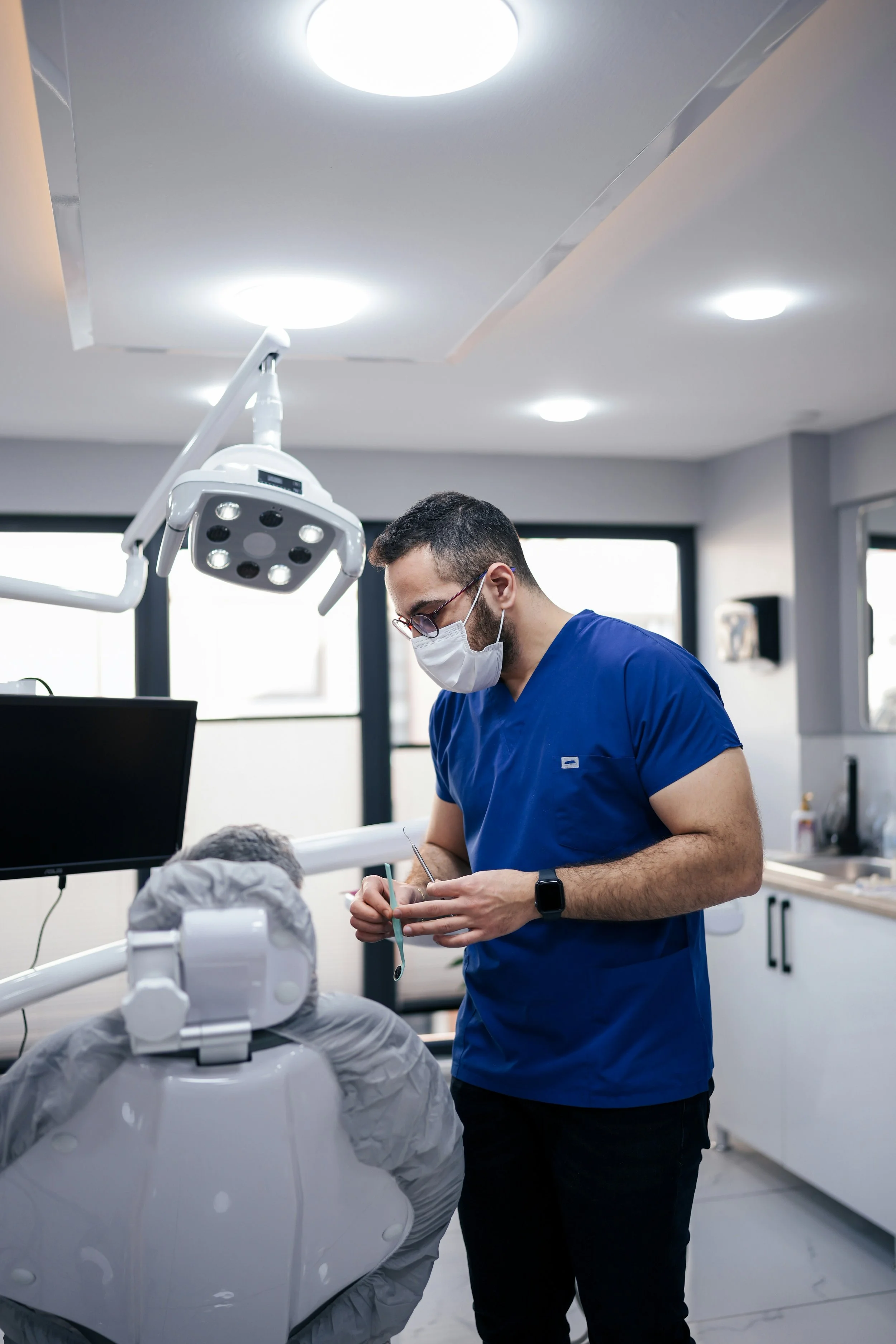 Dentist consulting with patient – symbolizing controller services and financial oversight for dental offices.