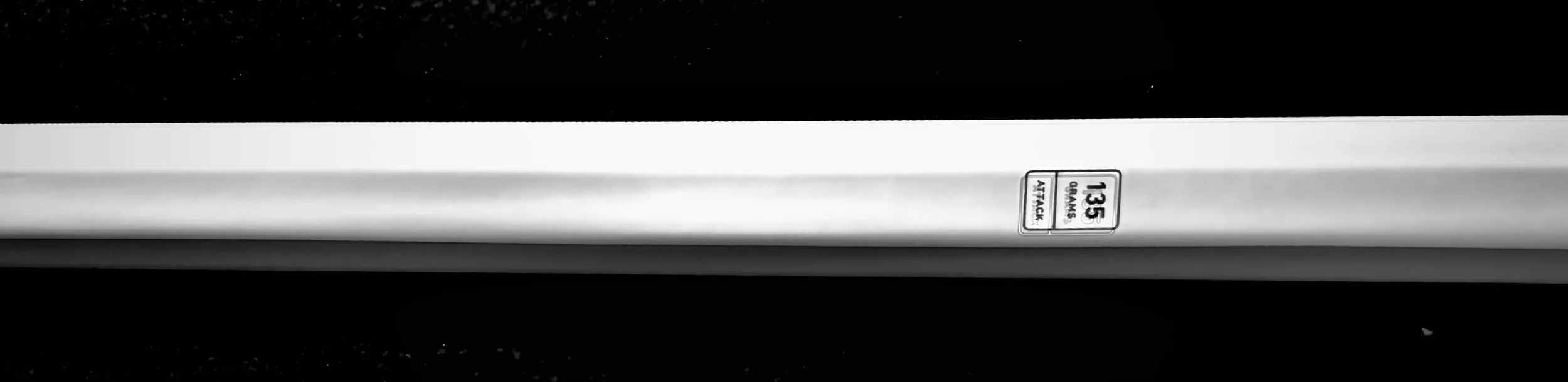 close up of a white lacrosse shaft