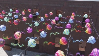 Hot air balloons and colorful wind spinners above downtown Iron Mountain Main Street