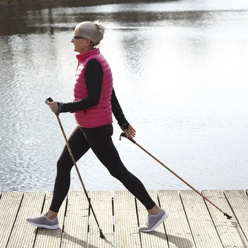 full-length-side-view-of-woman-nordic-walking-by-royalty-free-image-1690224160.webp