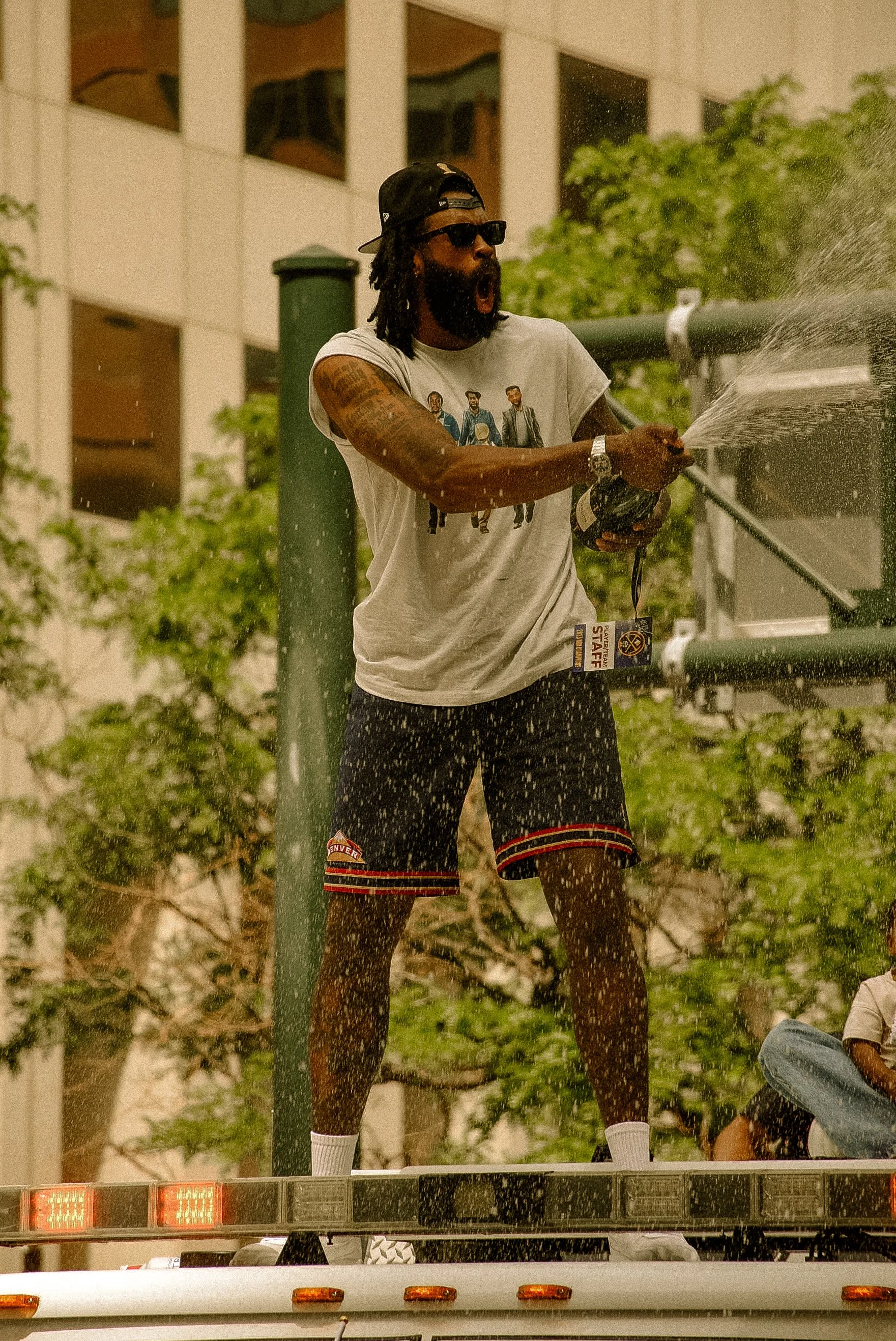 DeAndre Jordan of the Denver Nuggets pops champagne during the Nuggets championship parade in June of 2023.