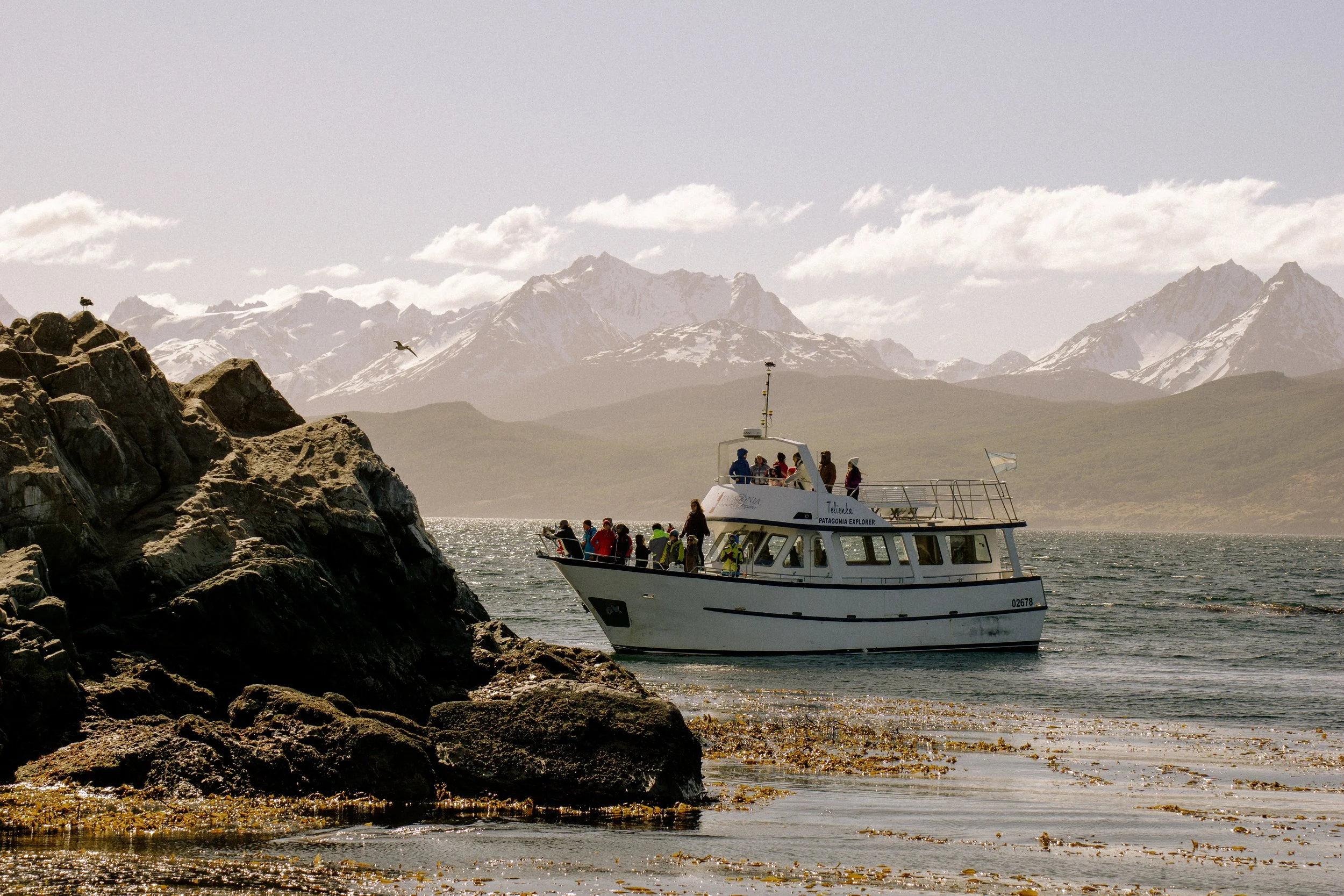 A group of tourists on a boat tour in Ushuaia, Argentina.