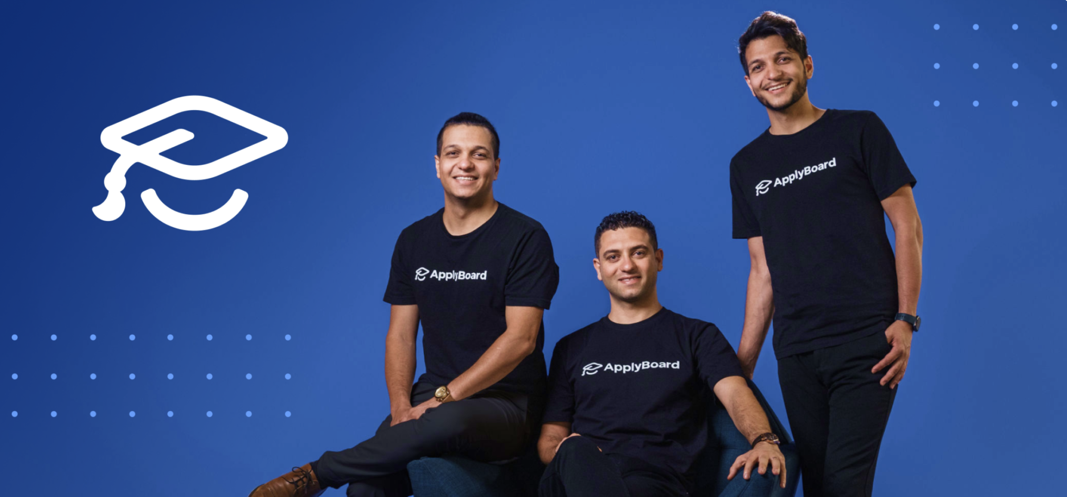 Three men wearing black shirts with ApplyBoard logo, posing against a blue background, with a white graduation cap icon in the top left corner.