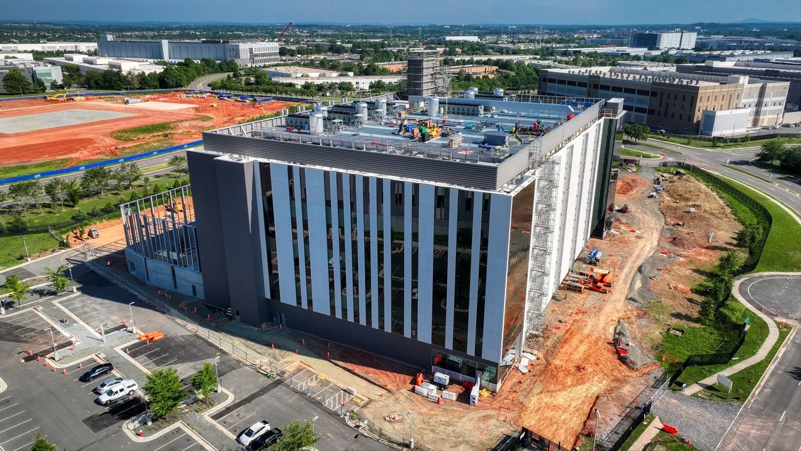 Aerial view of the Equinix DC22 data center building under construction, showcasing modern structural engineering and exterior facade details.