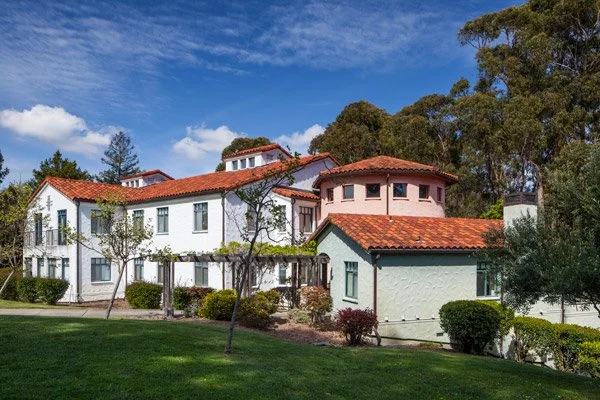 Exterior view of Prospect Hill Dormitory at Mills College in Oakland, CA, featuring classic architecture with red tile roofs and structural engineering by PARADIGM.