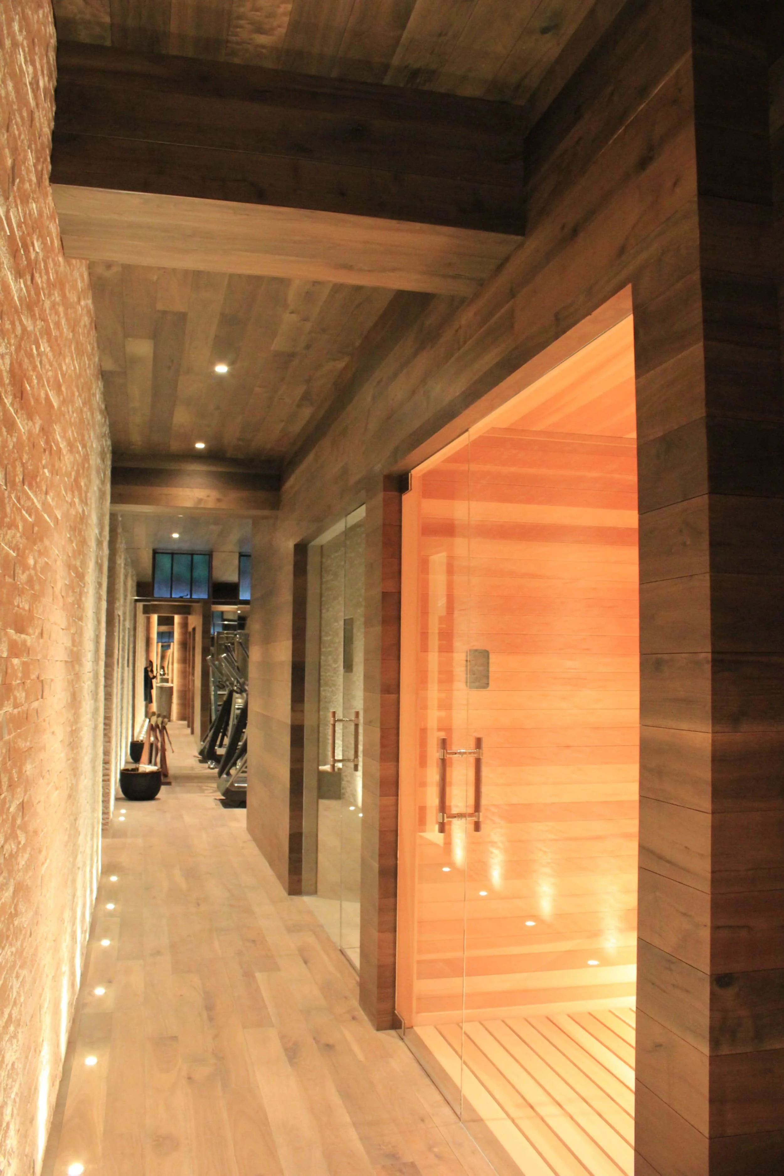 Custom wood-paneled sauna interior and structural framing by PARADIGM at 3450 Washington.