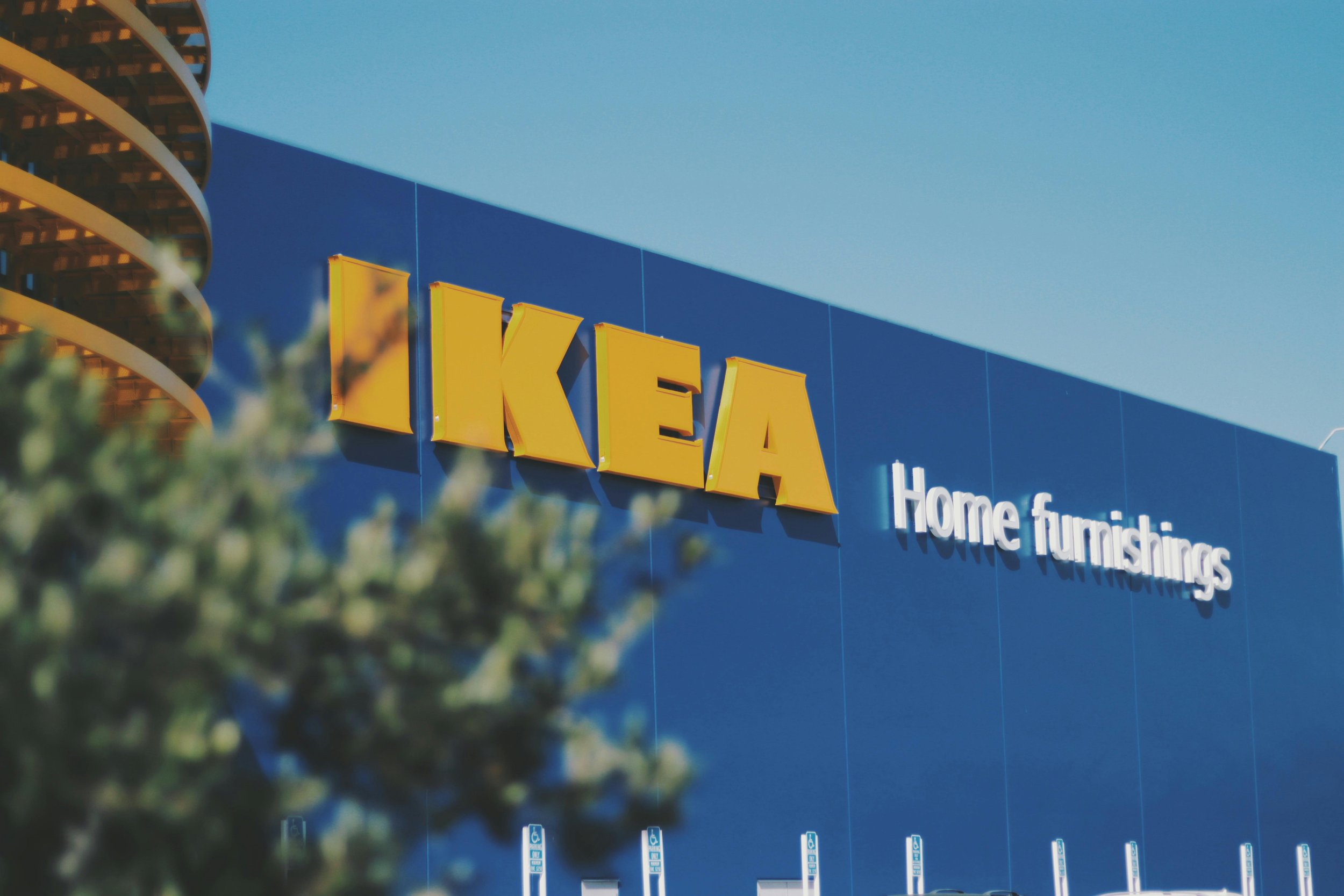 Close-up exterior view of the IKEA Home Furnishings blue facade signage, showcasing the iconic branding and architectural detailing.