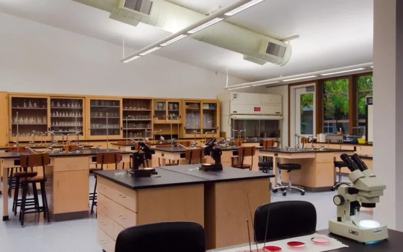 Interior view of the science lab at Brennan Hall, Holy Names University in Oakland, featuring microscopes, cabinetry, and structural engineering by PARADIGM.