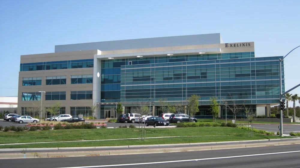 PARADIGM Structural Engineers 249 East Grand Avenue corporate office exterior view featuring the EXELIXIS sign, glass facade, and parking lot.
