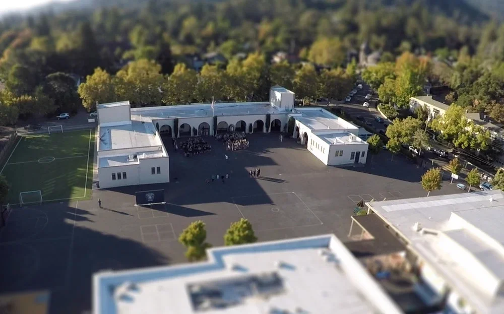 Aerial overview of St. Anselm School in San Anselmo showing the campus layout, courtyard, and surrounding neighborhood with engineering by PARADIGM.