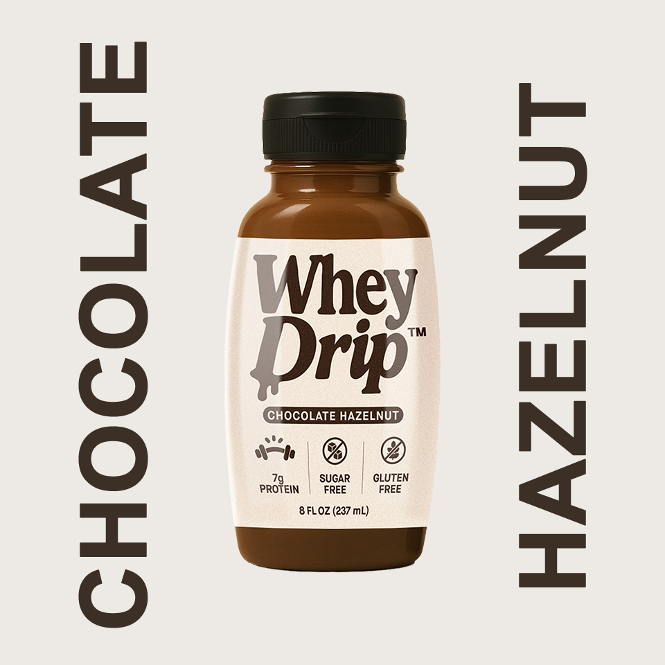 A bottle of Whey Drip Chocolate Hazelnut protein drink with label information about protein content, sugar-free, gluten-free, and 8 fl oz size.