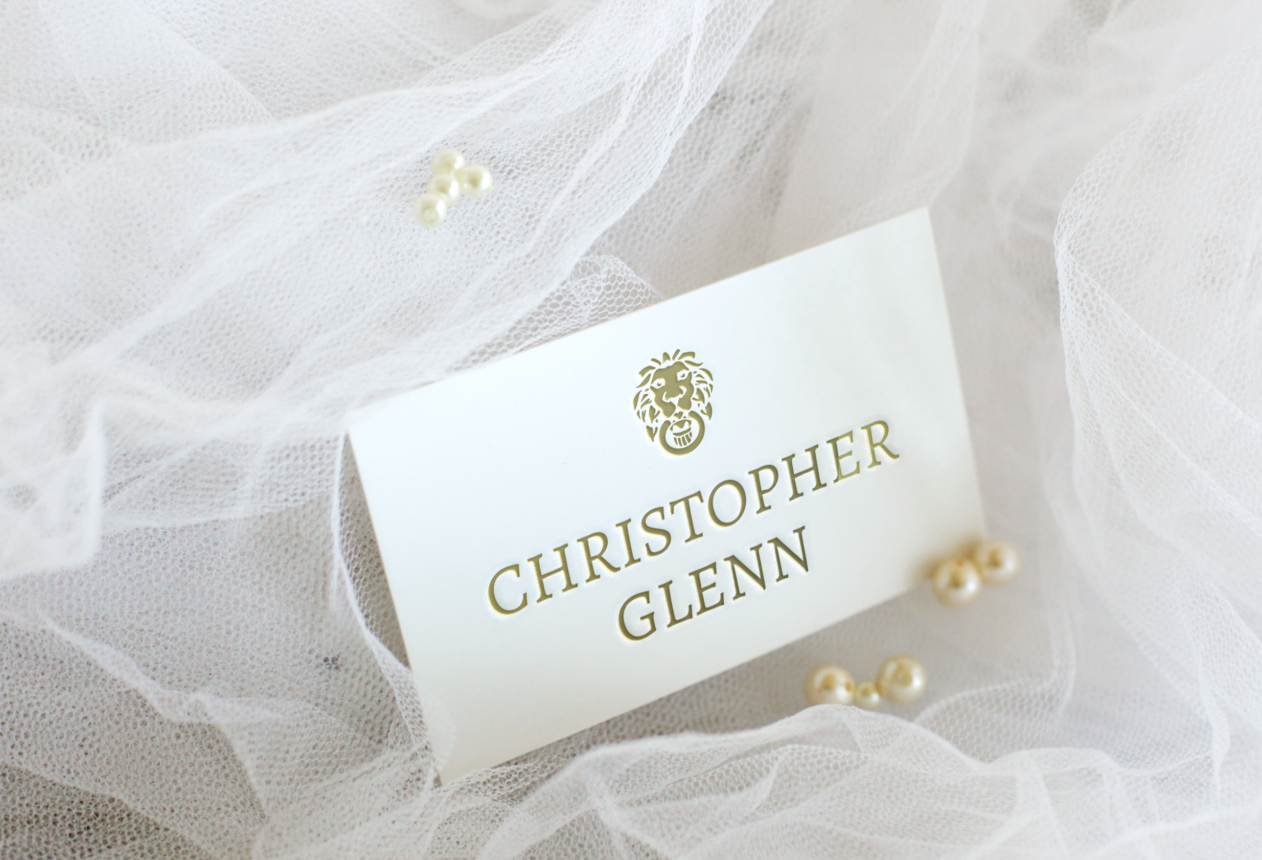 White tulle fabric with pearl accents and a card displaying the name Christopher Glenn.
