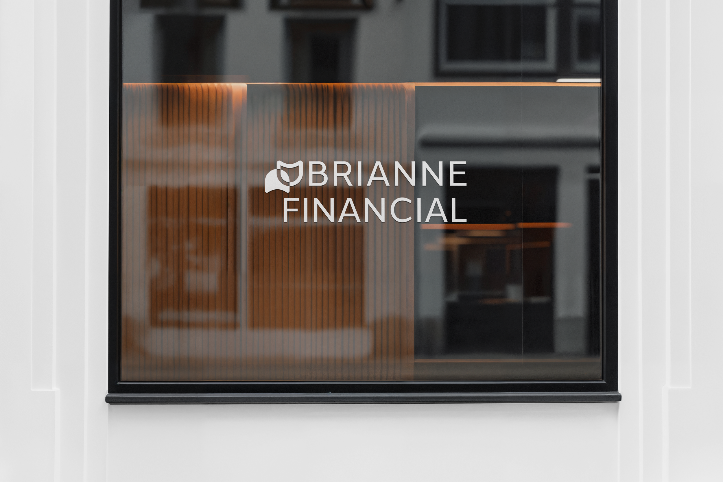 A glass door with the logo and name 'Brianne Financial' on it, showing a modern office interior with wooden accents inside.