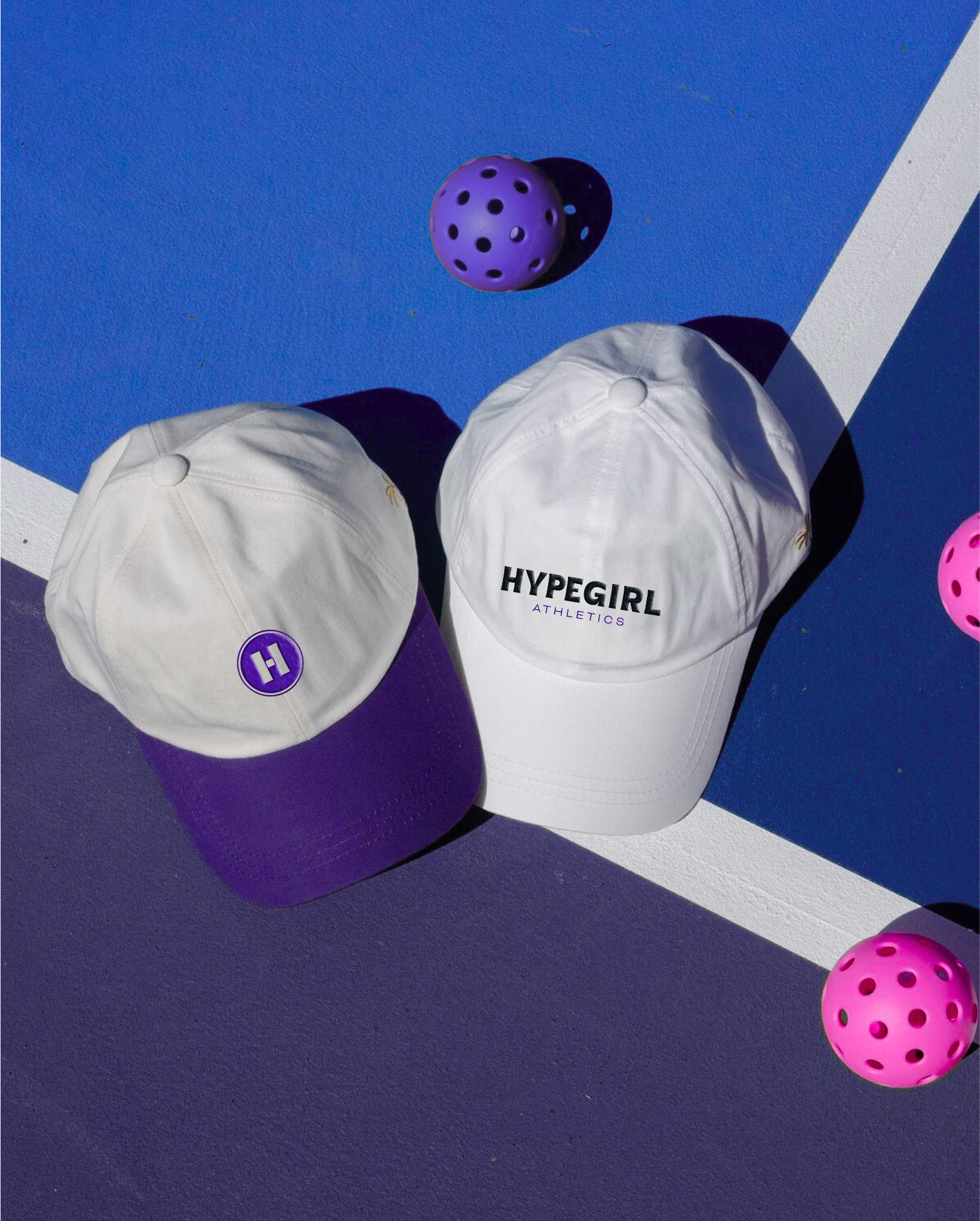Two white hats with purple and white brims, one with