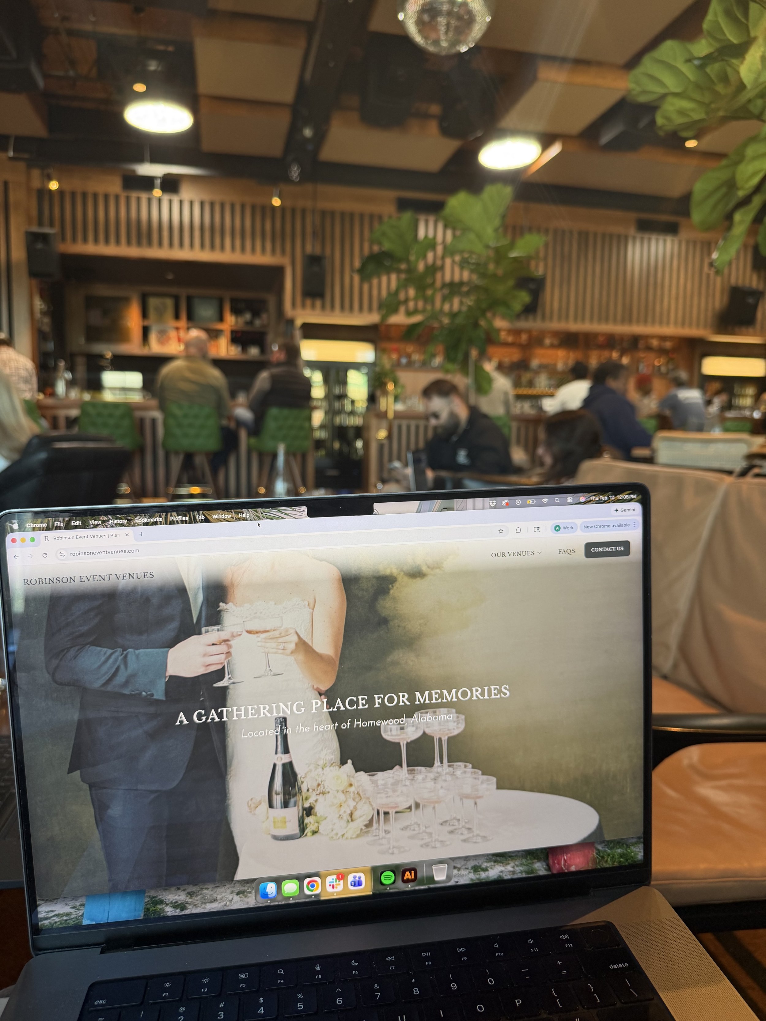 Laptop screen displaying a website for Robinson Event Venues, titled "A gathering place for memories" and located in Homewood, Alabama. The website banner features a couple holding glasses, celebrating, with a table set with wine bottles and glasses in the foreground.