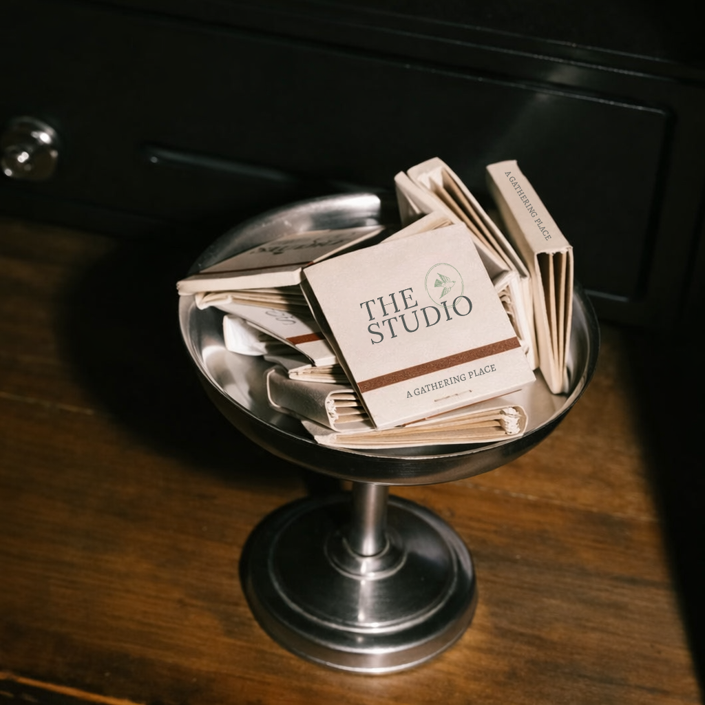 A metal bowl filled with folded paper brochures on a wooden table.