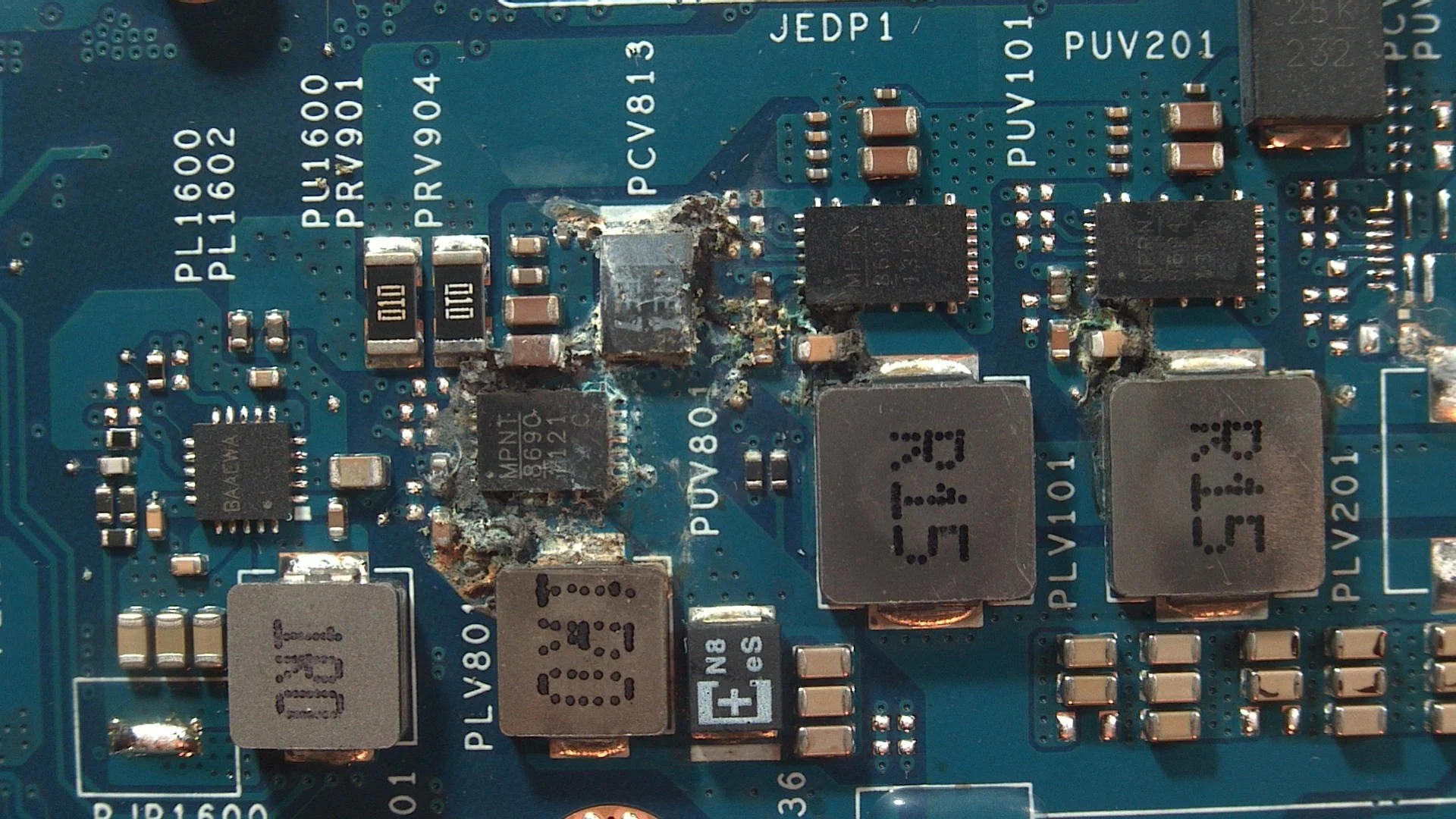 Corrosion and liquid spill residue on a Dell XPS 15 9530 laptop motherboard before repair