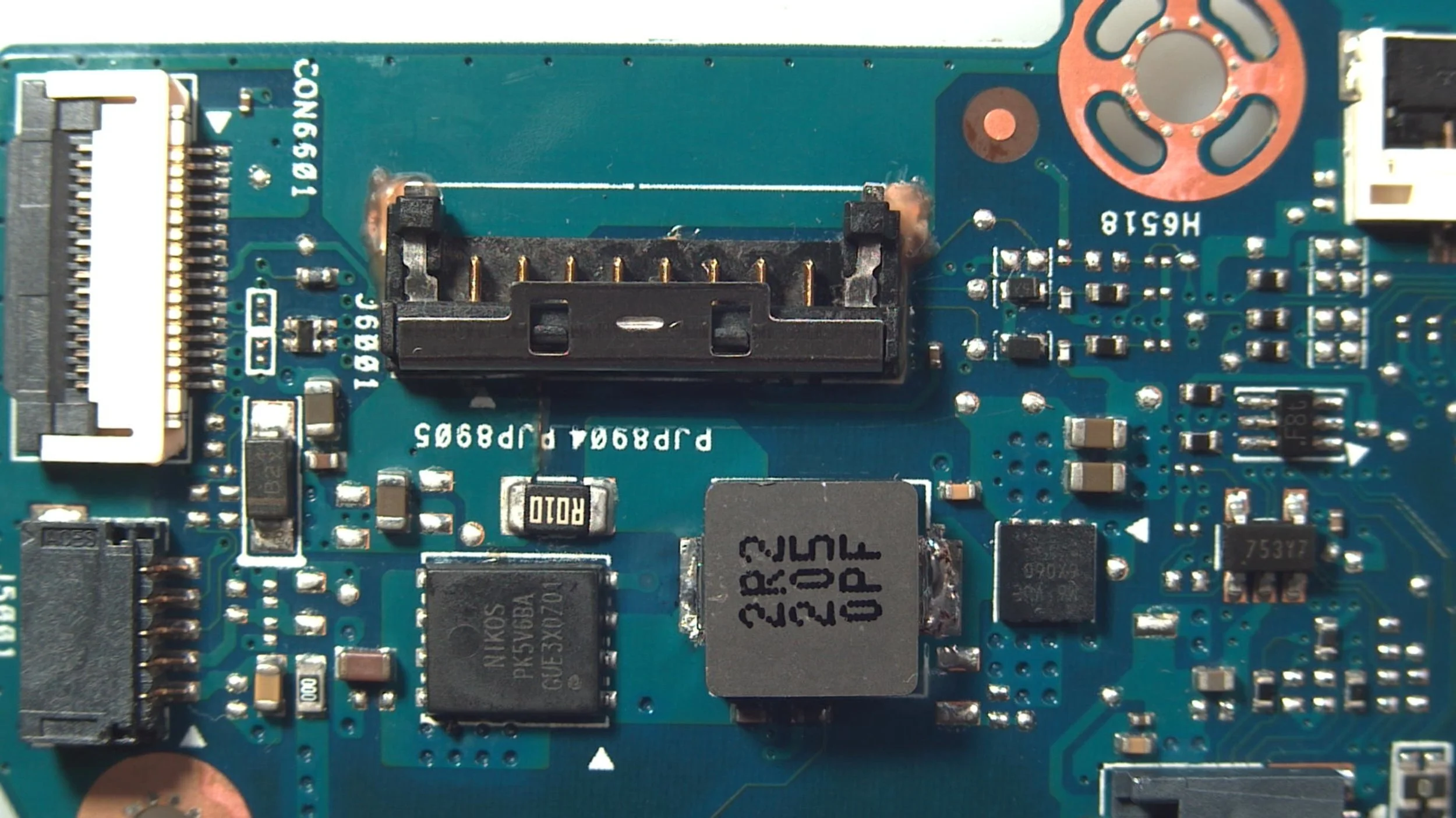 New battery connector soldered onto reconstructed motherboard traces of an Asus Vivobook S 16X