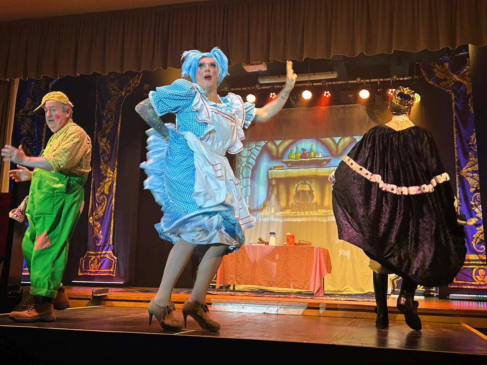 Stage performers dressed as cartoon characters in colorful costumes during a theatrical production.