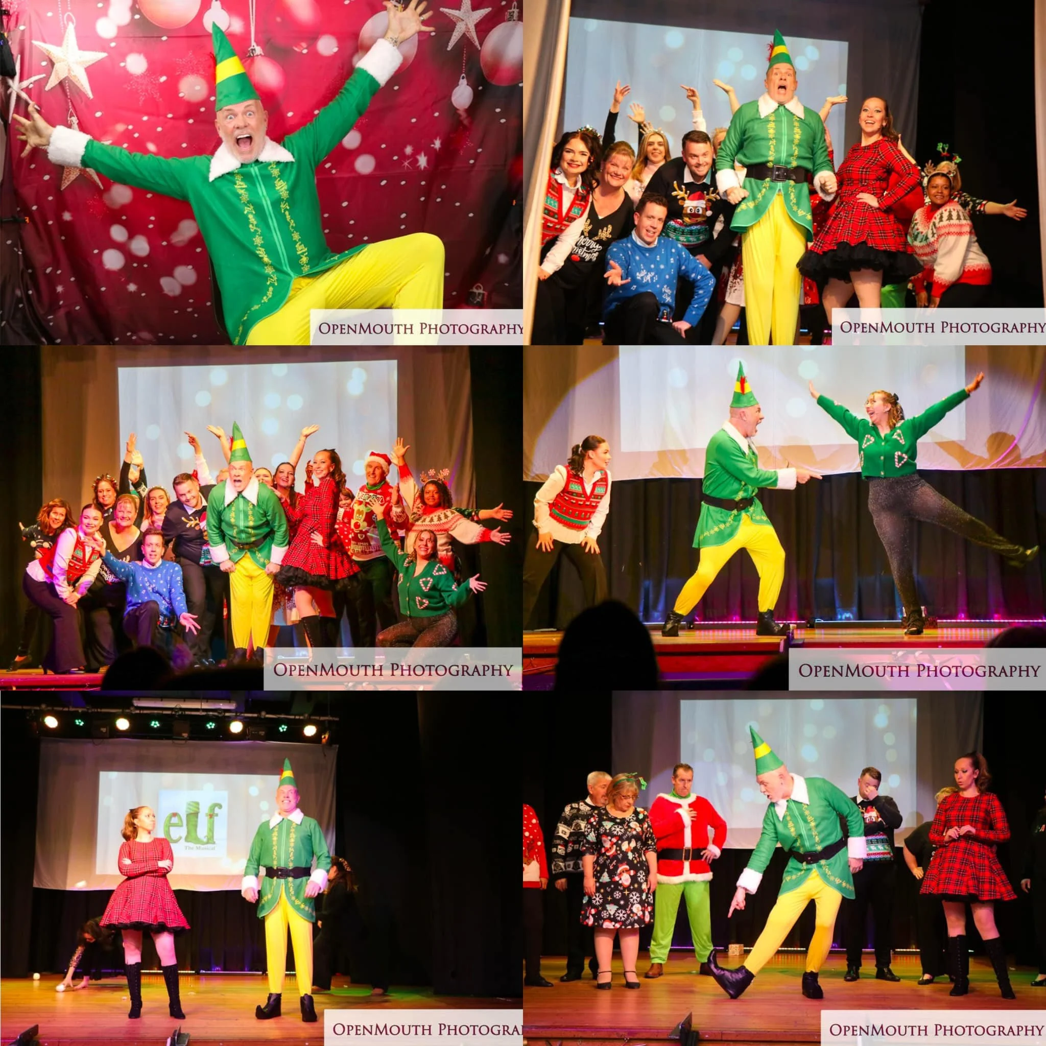 Group of performers dressed in holiday costumes on stage with a man in an elf costume at the center, engaging in a lively performance.