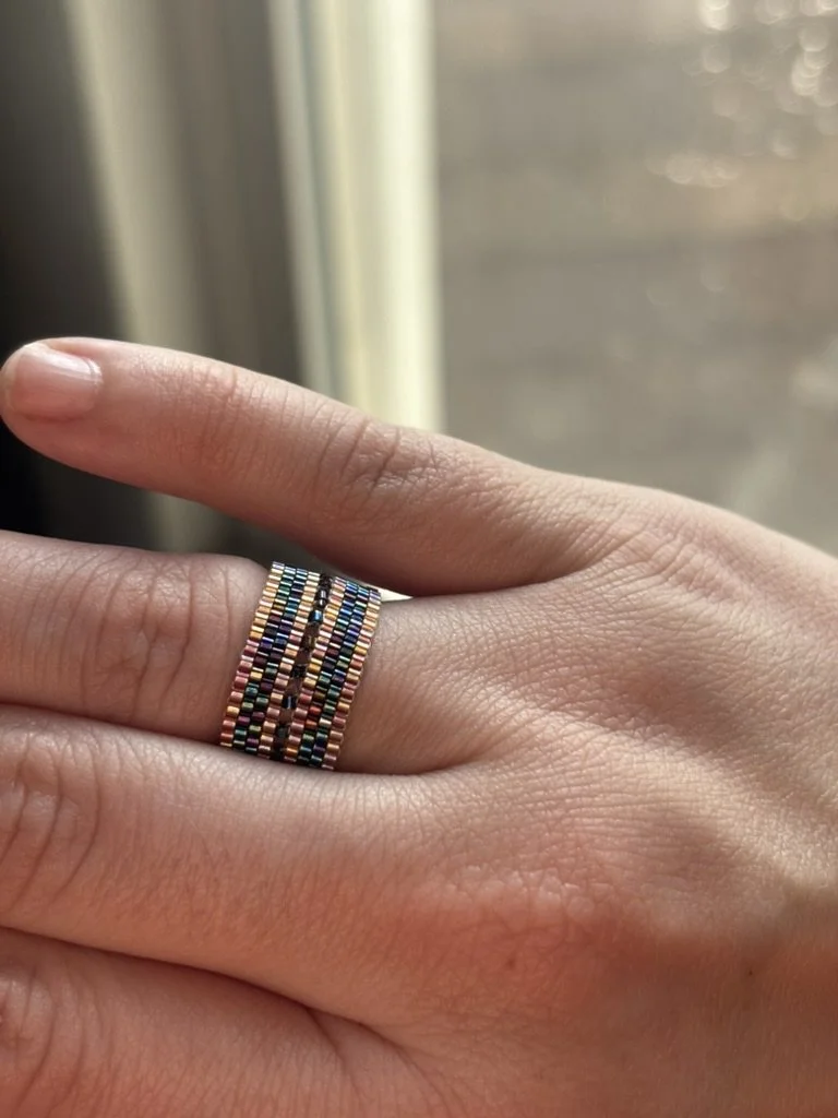 The Mirror Stacked Mango Black Rainbow ring displayed on a hand