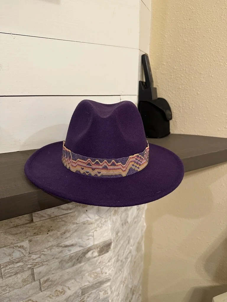 A beaded hat band on a bright purple hat