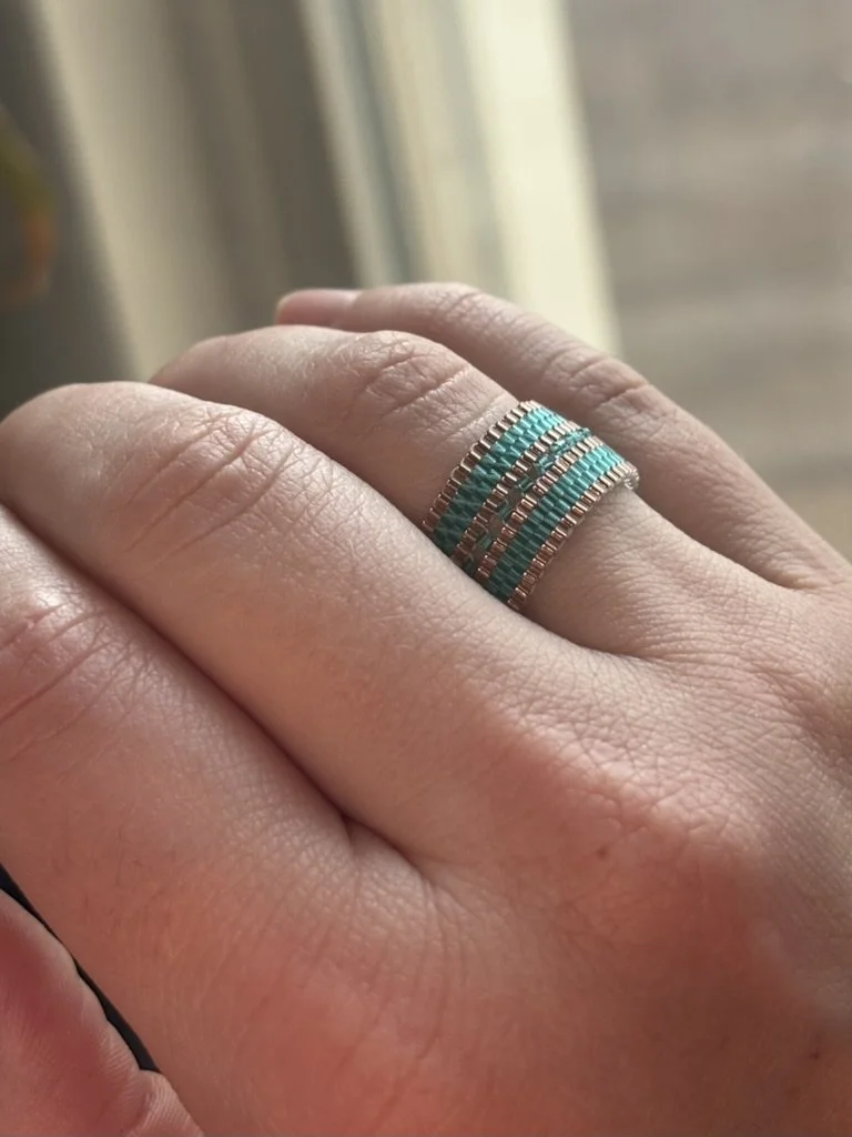 another view of The Mirror Stacked Aqua Rose ring displayed on a hand