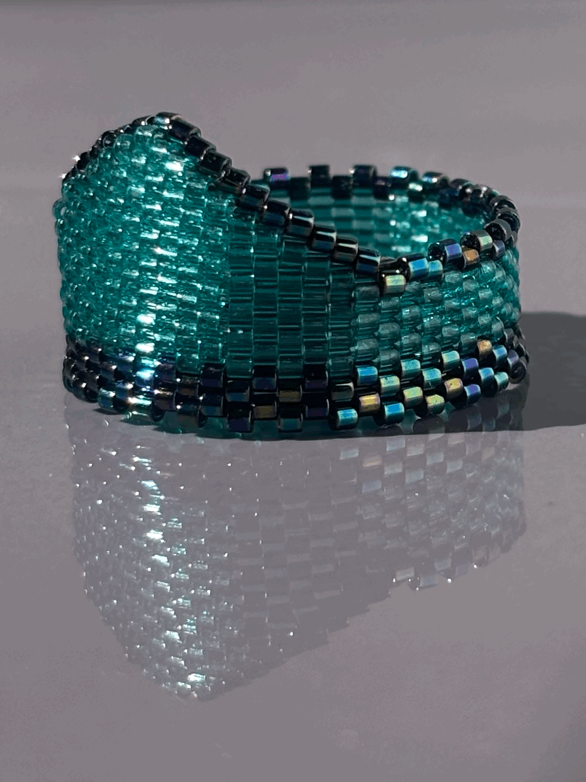 Left-side view of the Aqua Iris Widow’s Peak ring