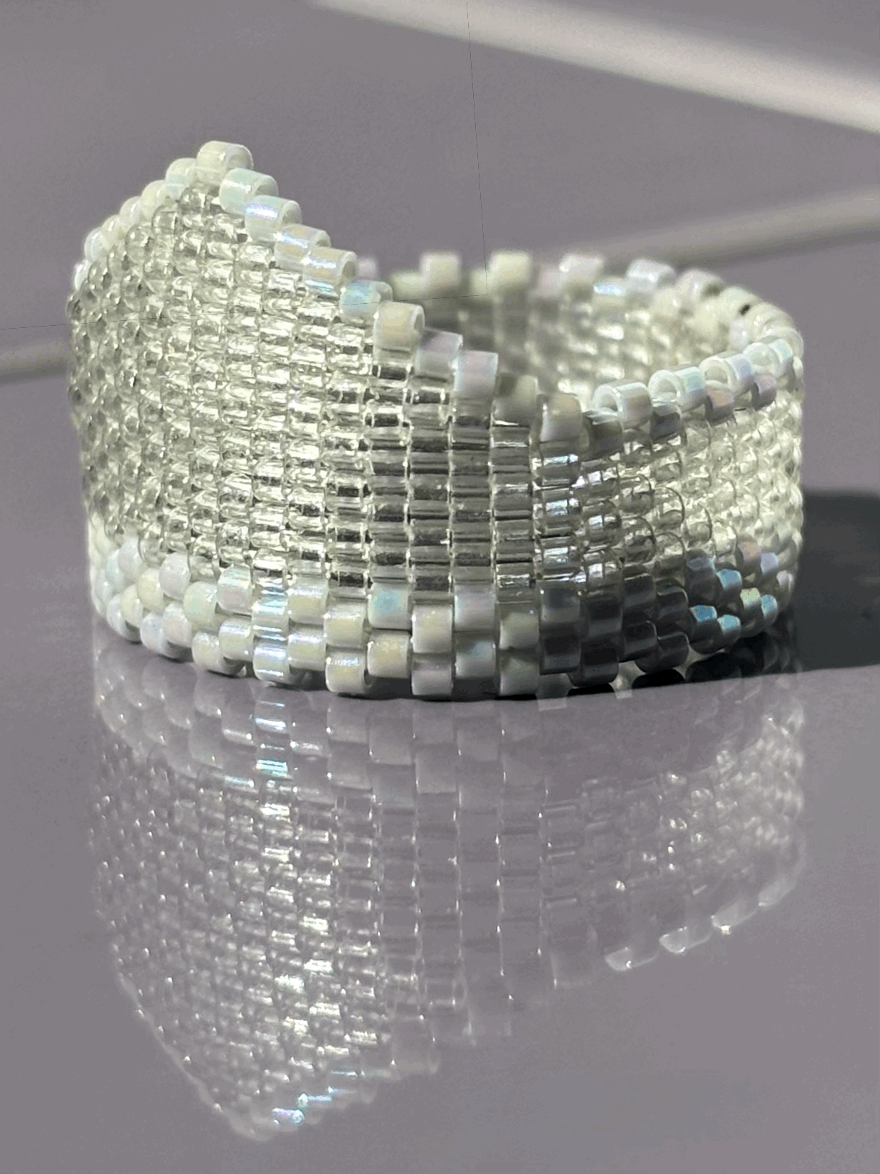 Left-side view of the Ghost Grey Iridescent Widow’s Peak beaded ring