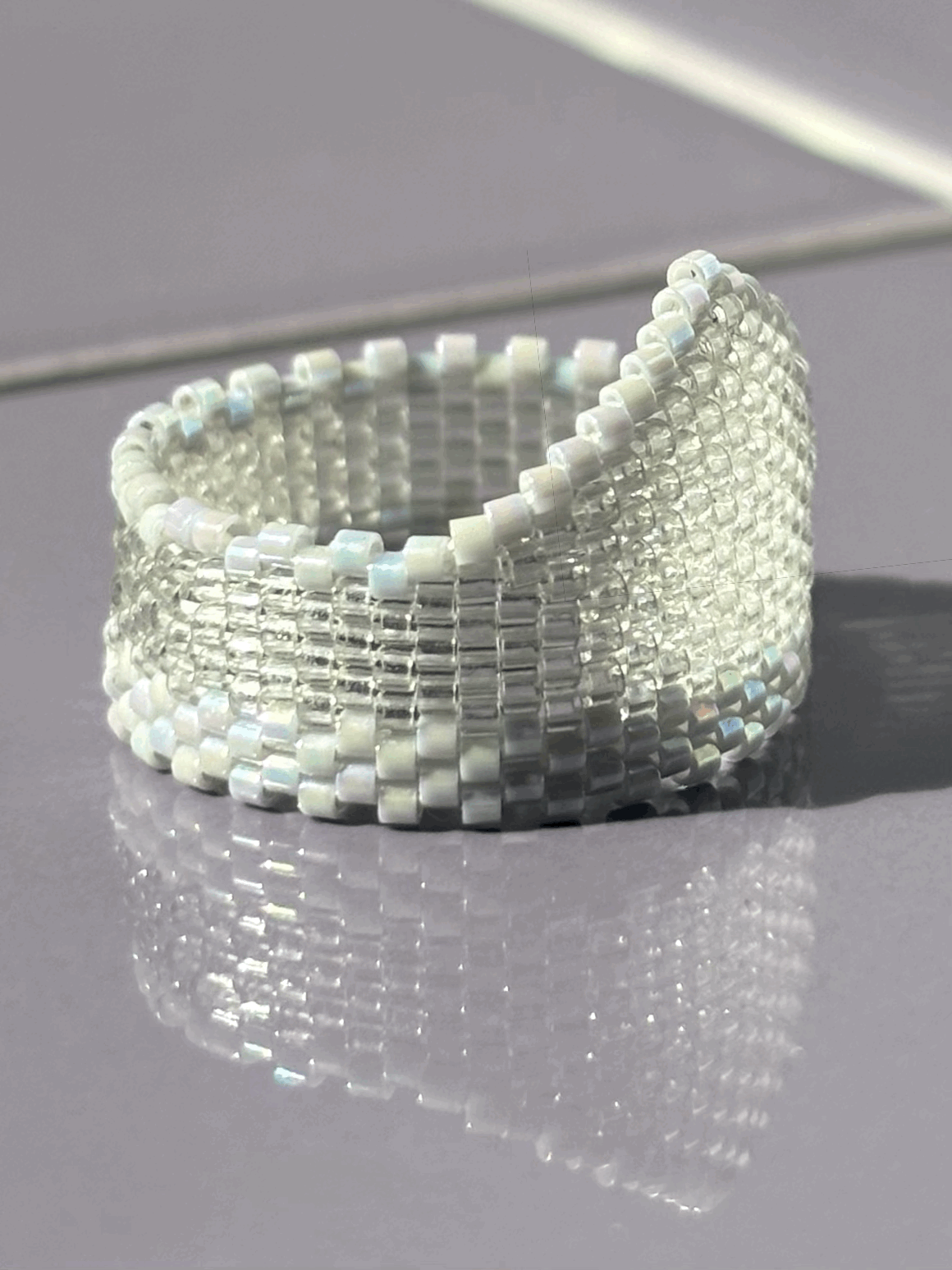 Right-side view of the Ghost Grey Iridescent Widow’s Peak beaded ring