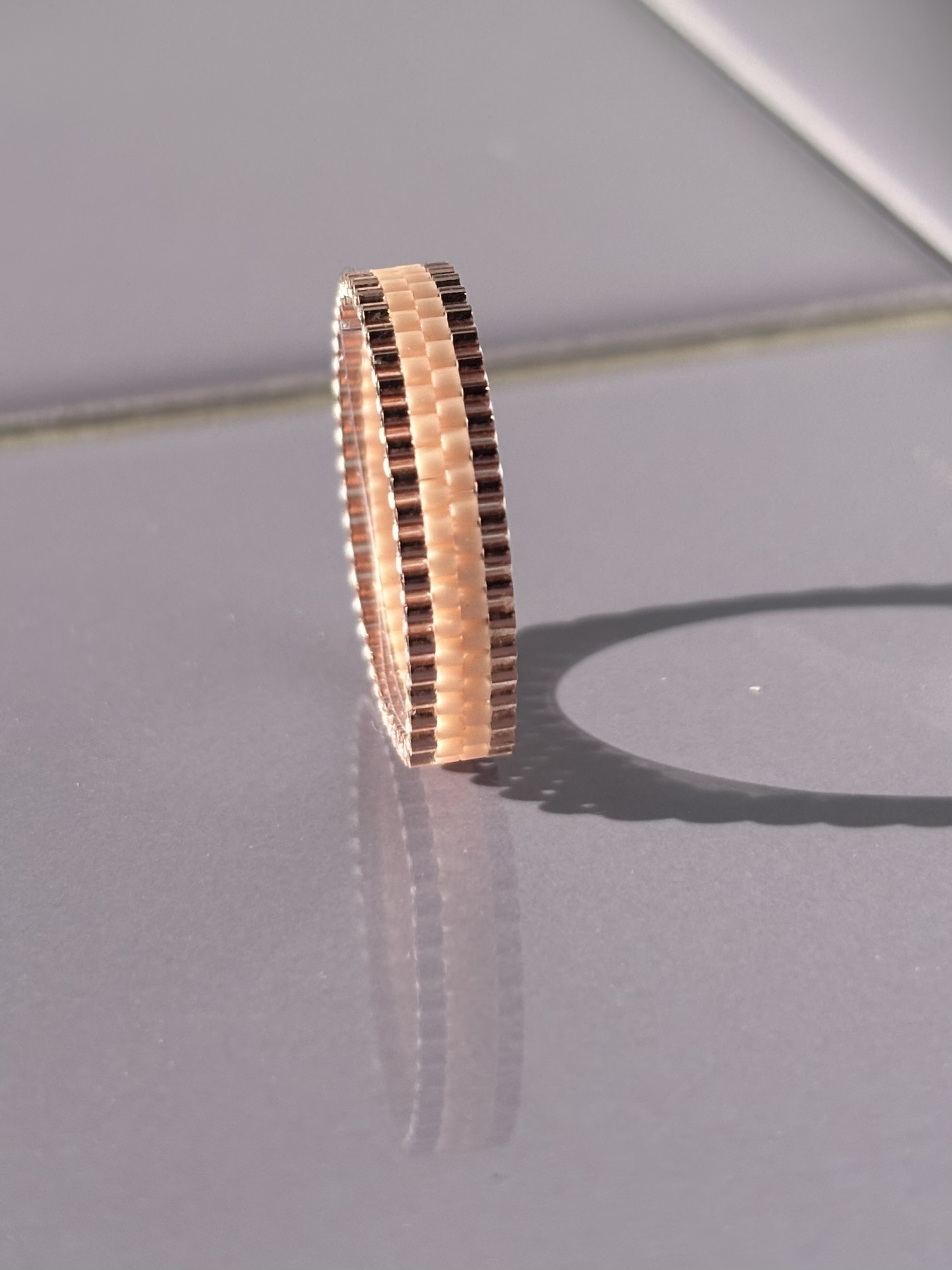 Upright view of the Metallic Rose baby pink stackable ring