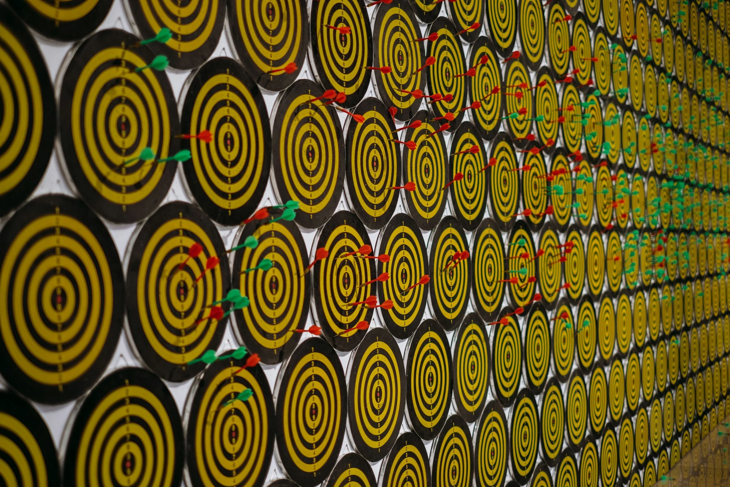 Multiple, consistently repetitive yellow and black circular boards with red, green, and yellow colors.