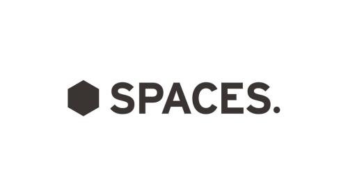The image features the logo of Spaces, with a black hexagon icon next to the word 'SPACES' in bold black letters on a white background.