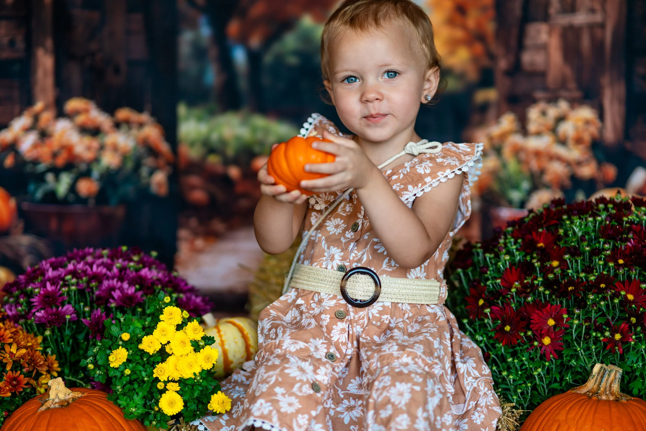 A young child with wet hair and dark eyes, looking at the camera, with clasped hands resting on a surface, black and white photo.