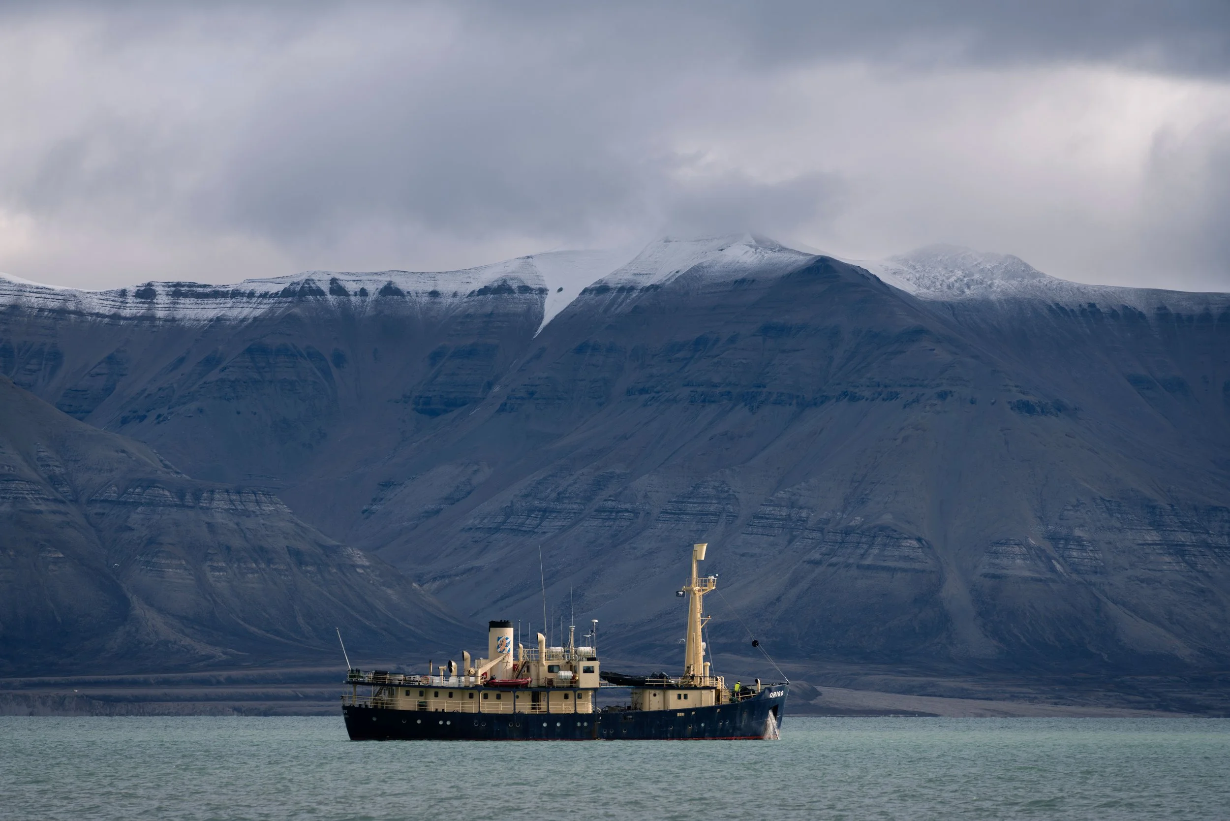 Arctic Vessel Beneath the Mountains