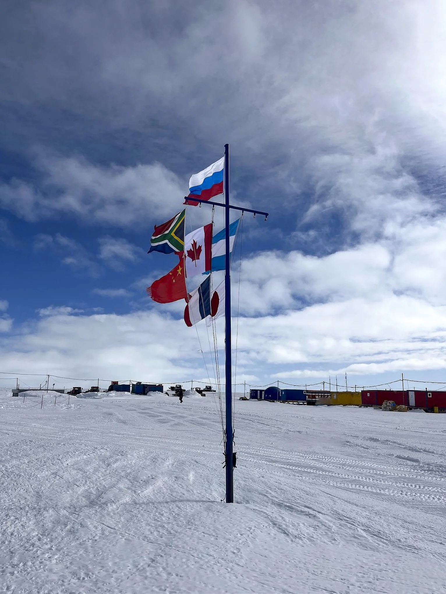 Novolazarevskya Research Station and Novo blue-ice runway displaying the flags of the participating nations. 
