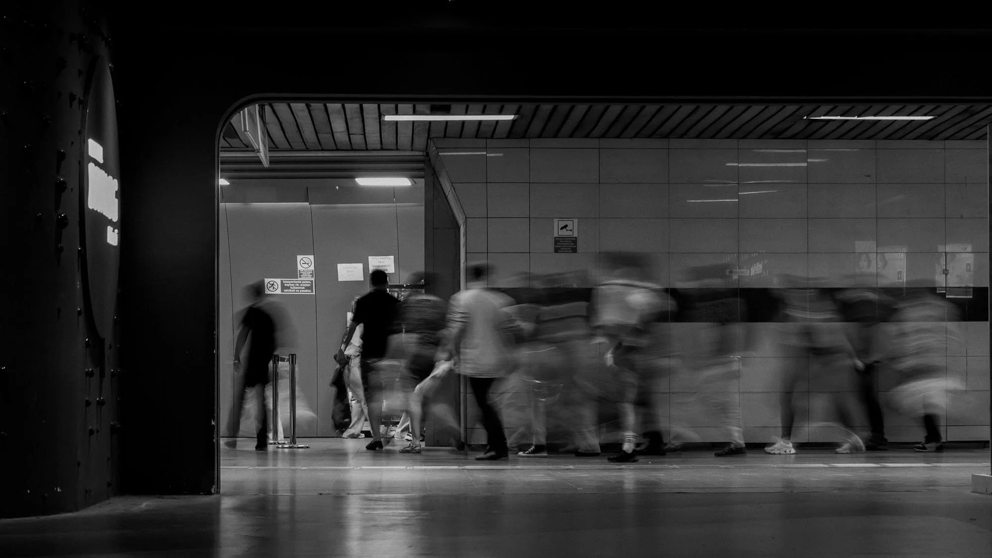 Blurred business leadership executives in motion through transit hall