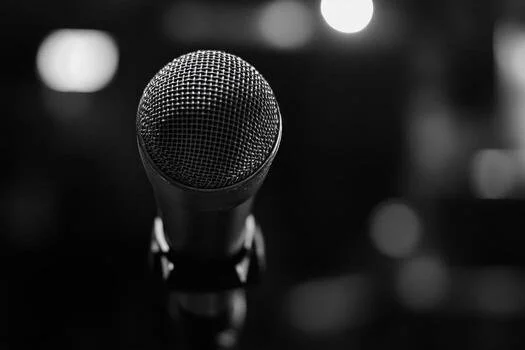 a-microphone-is-shown-in-black-and-white-photo.jpeg