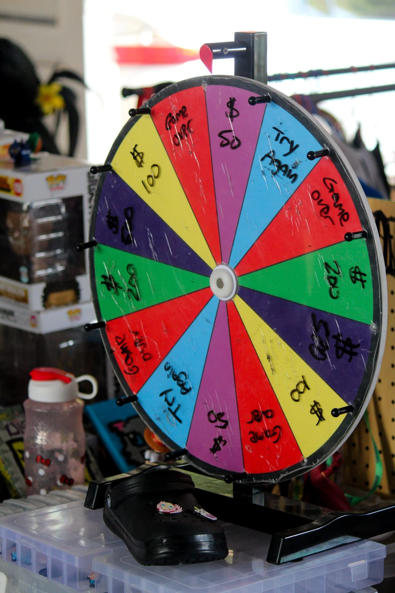 Colorful prize wheel with various sections marked with dollar amounts and tasks like 'Come Once,' 'Try Again,' and 'Win a Prize.'
