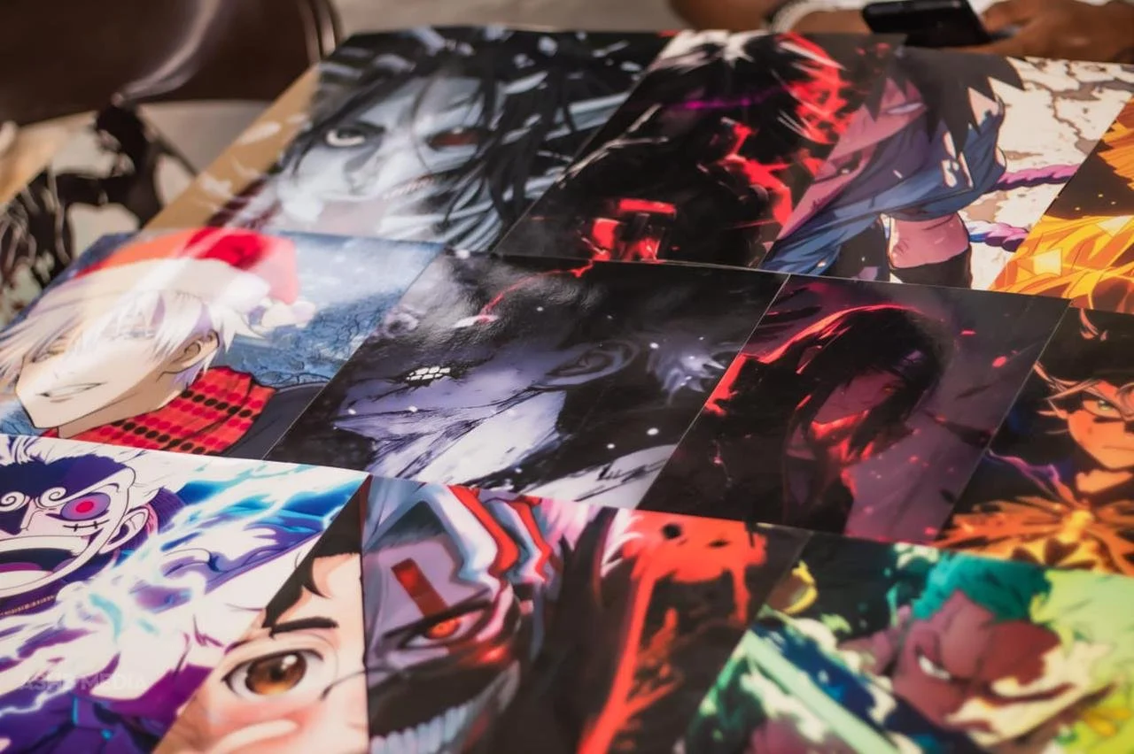 Collage of colorful anime character posters on a tabletop.
