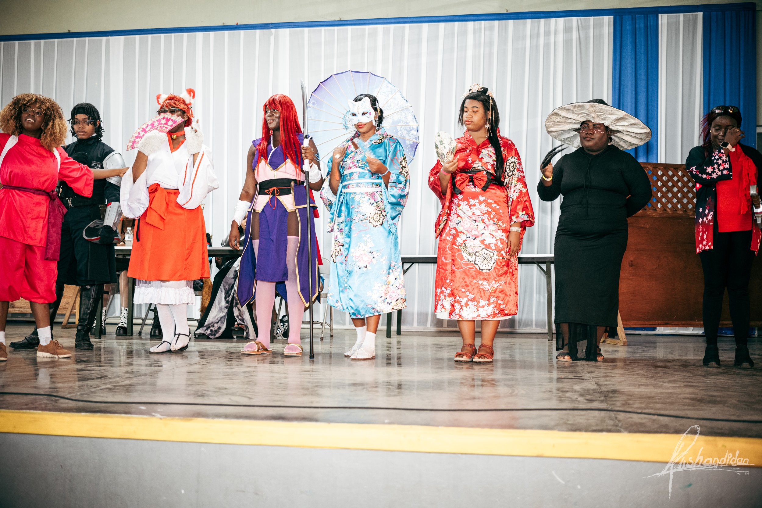 People in costumes on stage during a performance
