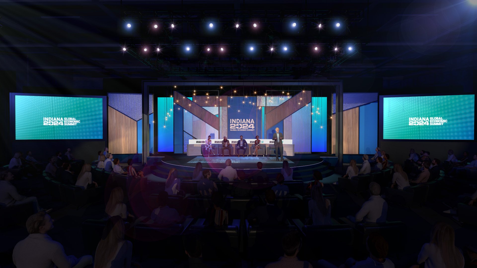 Stage at the Indiana 2024 Global Economic Summit with panel of speakers, audience seated, large screens displaying the event logo, and decorative lighting.