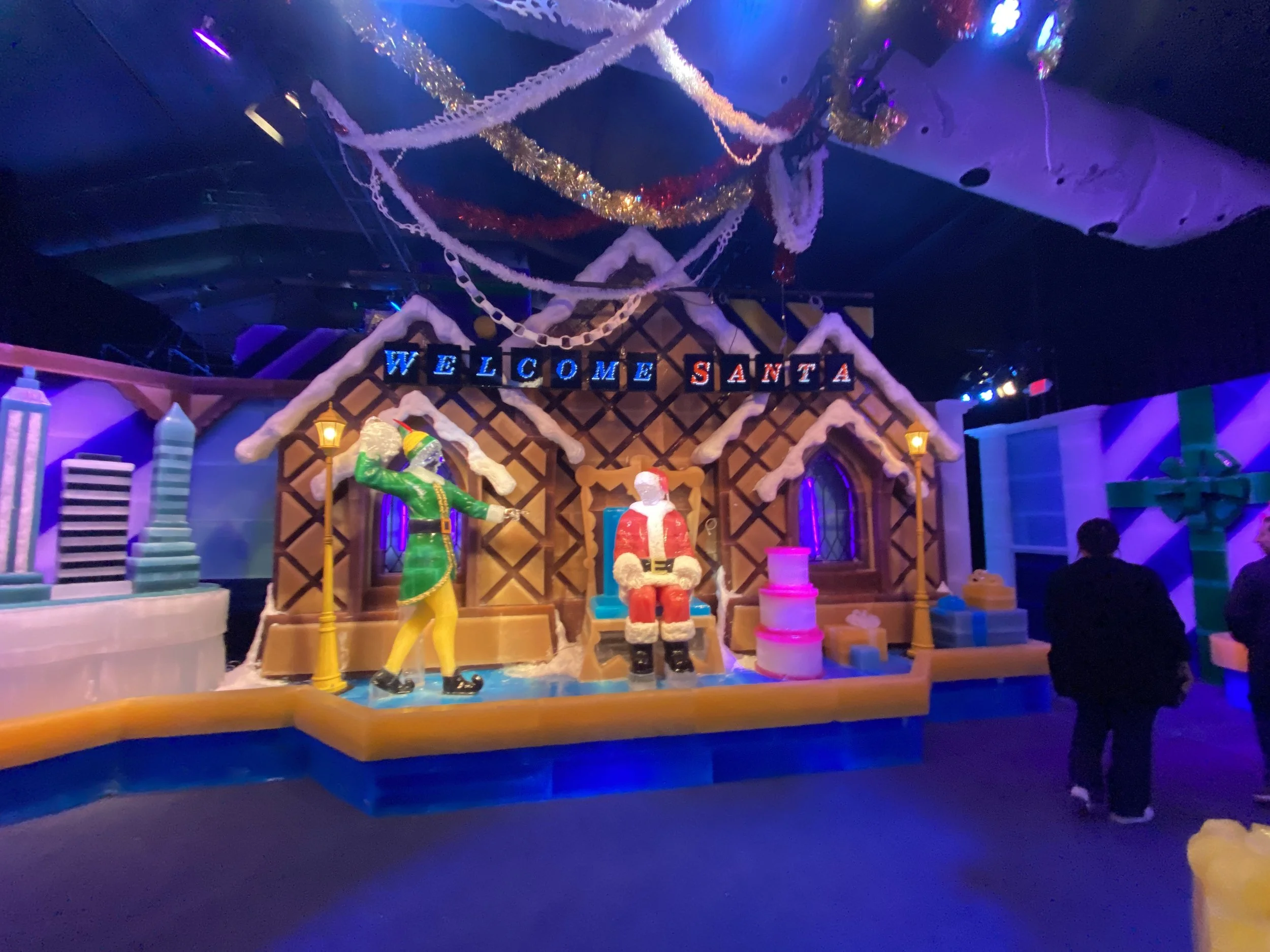Colorful Christmas-themed indoor display with Christmas decorations, including a 