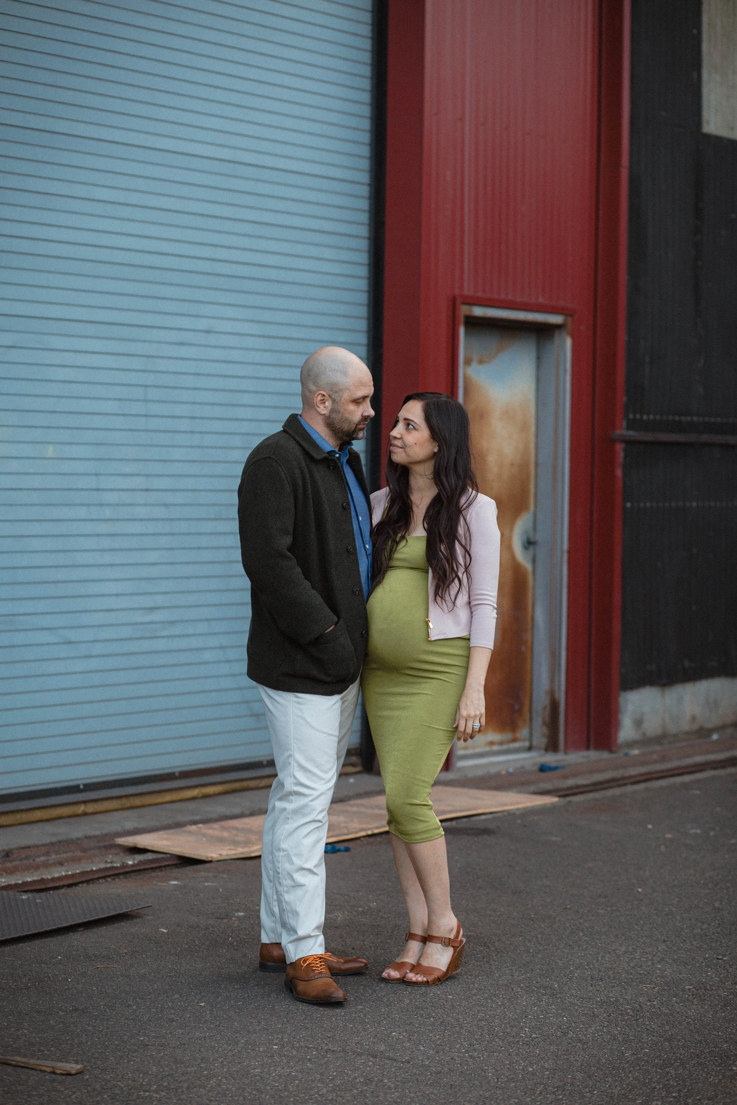 A couple embraces each other in a close up image taken during blue honor at Edmonds beach, the couple is celebrating their engagement.