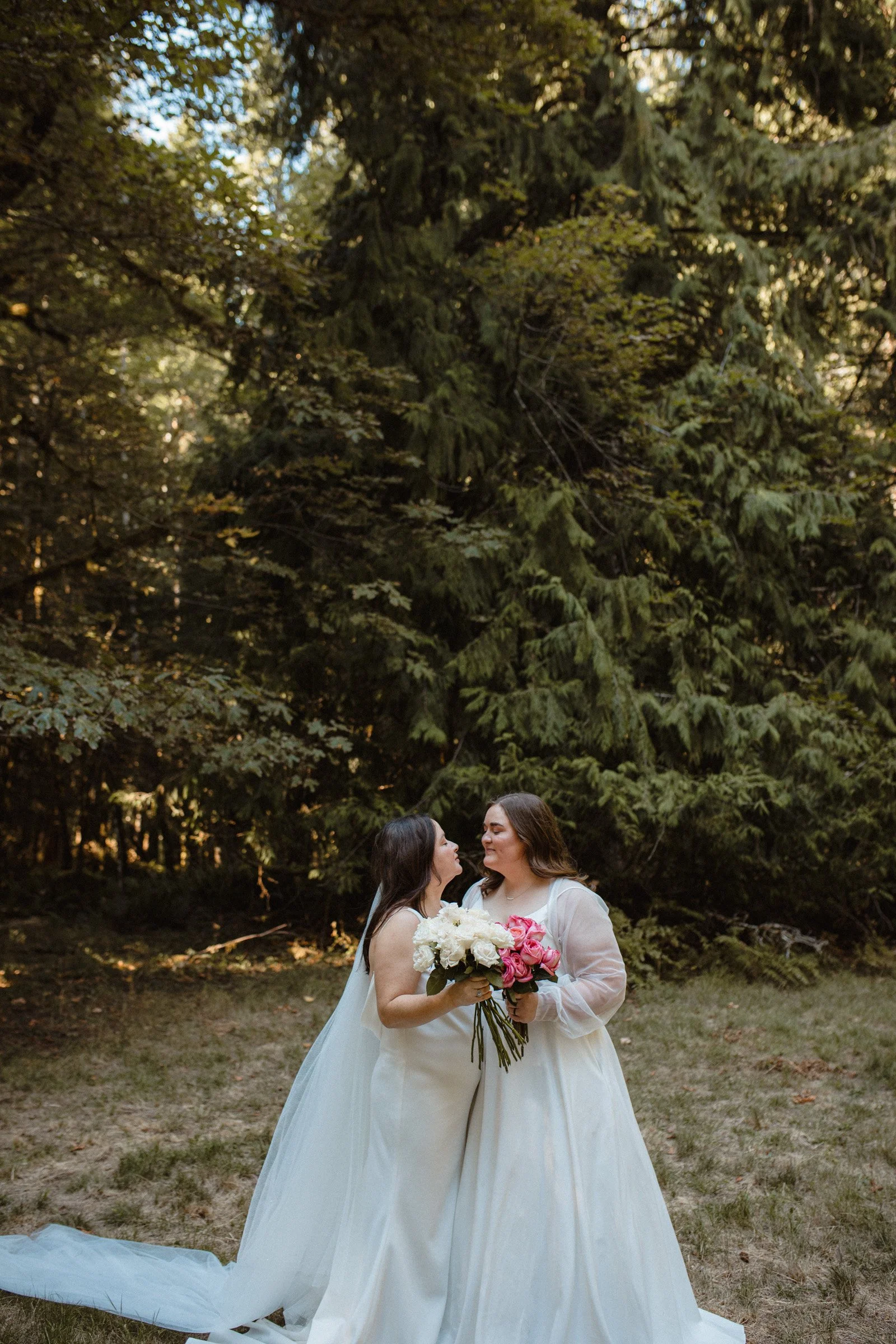Two brides posing together during wedding portraits in Port Angeles, Washington